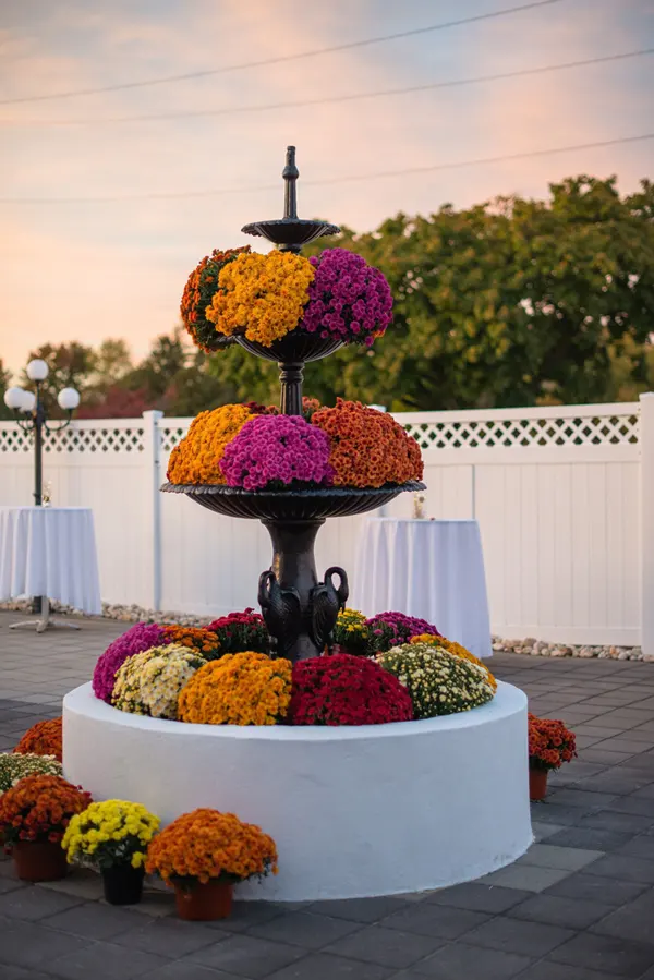 Autumn wedding with colorful flowers set in the fountain
