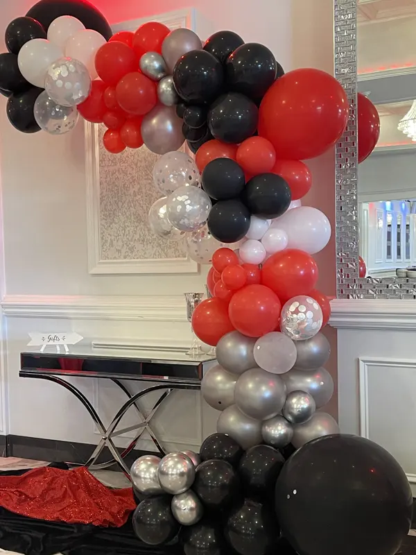 Balloon display with red, white, black and silver balloons