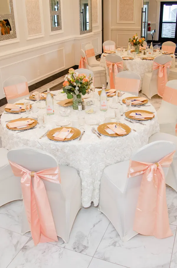 White and coral colored table setting