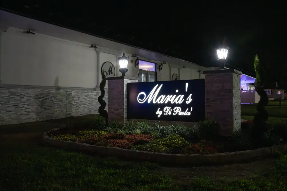 Maria's sign lit up at night